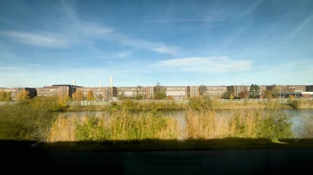 Shot of Wolfsburg Volkswagen factory in Germany from a train at morning