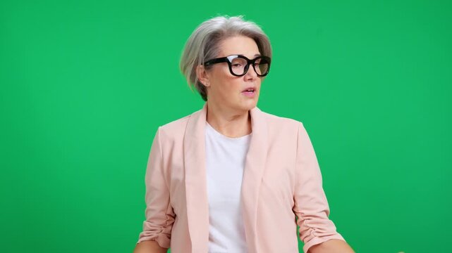 Serious mature businesswoman reprimanding his team green screen background