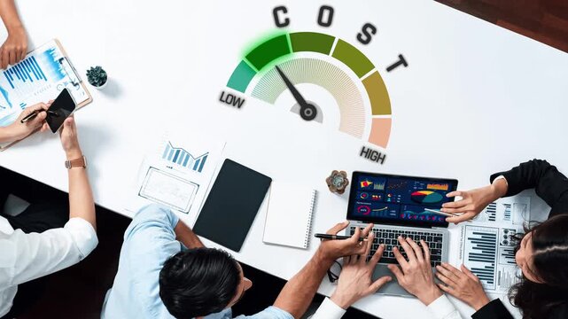 A top-down view of a business team engaged in financial analysis, utilizing graphs and digital tools to make informed decisions on cost management and planning. Raster