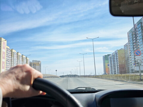 Driving on an open road in spring while enjoying a solo travel adventure