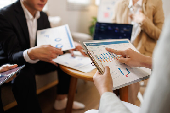 Business team analyzing financial data and marketing strategy