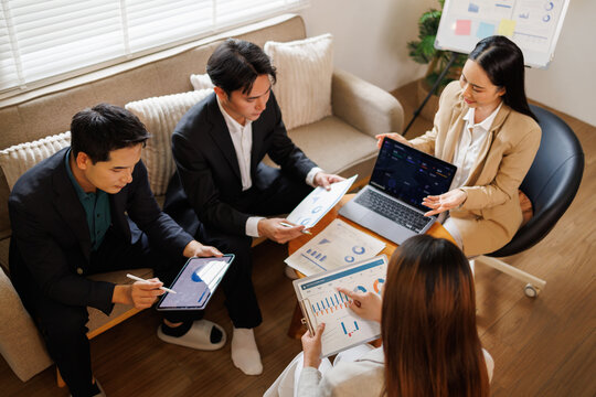 Business professionals collaborating on data analysis during startup meeting