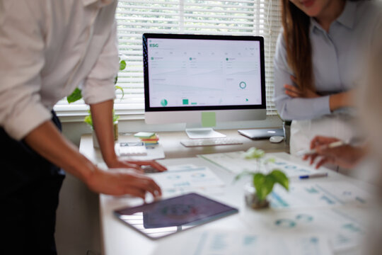 Business colleagues analyzing esg data for corporate sustainability strategy