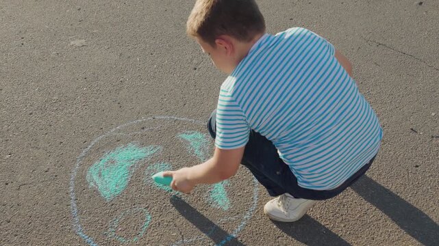 Clean planet Earth, boy child draws chalk asphalt, Kid child baby boy, Boy chalk Earth, early environmental lesson, street as canvas, kid making a difference, Earth in colors, drawing for change