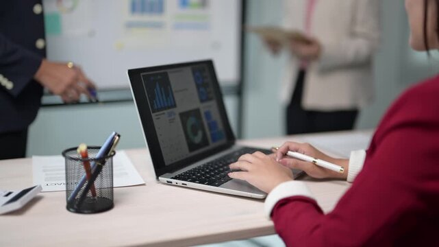 Business Meeting with Charts and Laptop in Modern Office Setup