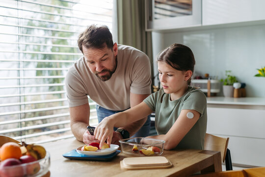 Parent helping diabetic daughter understand nutrition and sugar content.