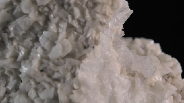 A macro of white quartz crystals isolated on a black background