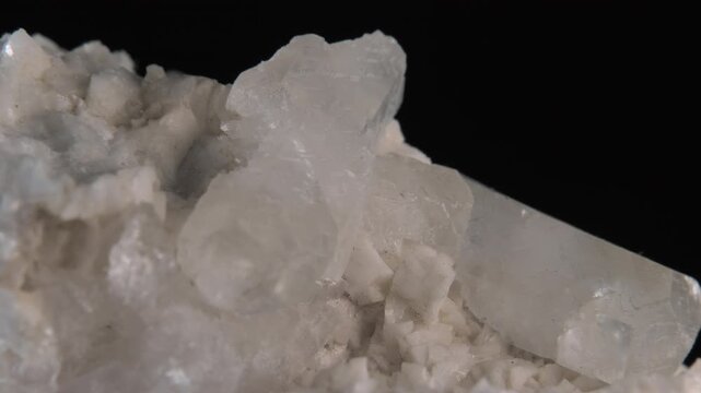 A macro of white quartz crystals isolated on a black background