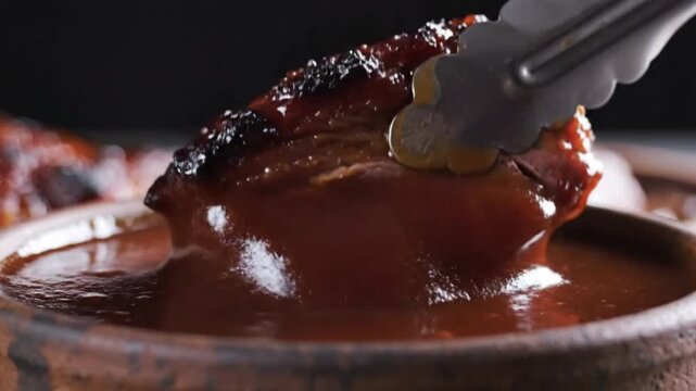 Dipping Braised Beef Meat into Rich Red BBQ Sauce