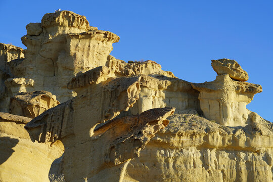 yellowish sandstone rock formations in Gredas de Bolnuevo