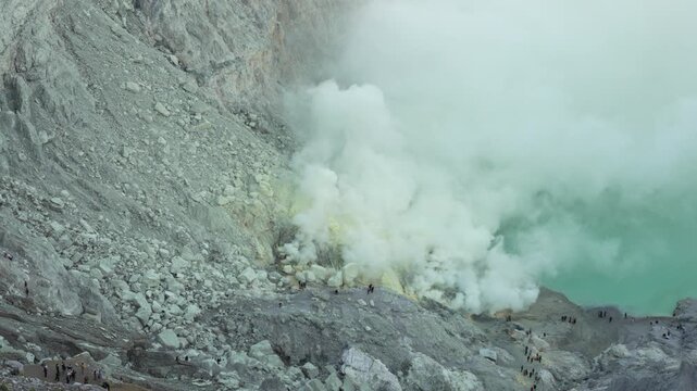 High Angle Handheld of Hikers Trekking Near Smoking Sulfur Vents at Mount Ijen