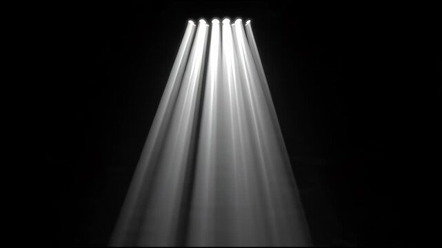 Cinematic White Volumetric Spotlight Beams Sweeping Across Dark Stage
