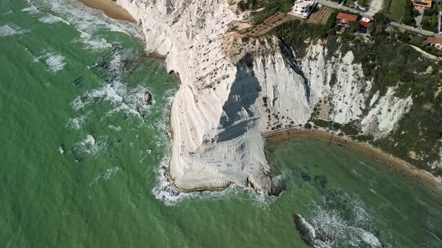 stair of the turks. Aerial view of white cliff formation along the coastline with turquoise waters and rocky shoreline, showcasing gradual erosion and natural beauty in a coastal region