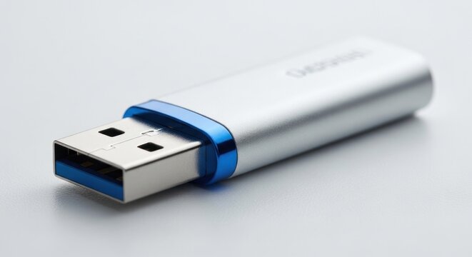 Silver and Blue USB Flash Drive on White Surface.