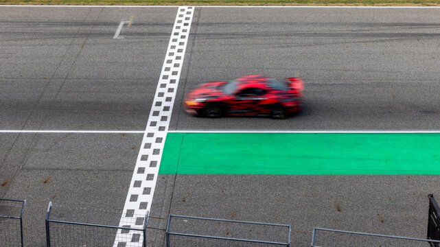 Motion blur, Race car racing on speed track, race car on road crossing start and finish line, Target business achieve and victory concept.