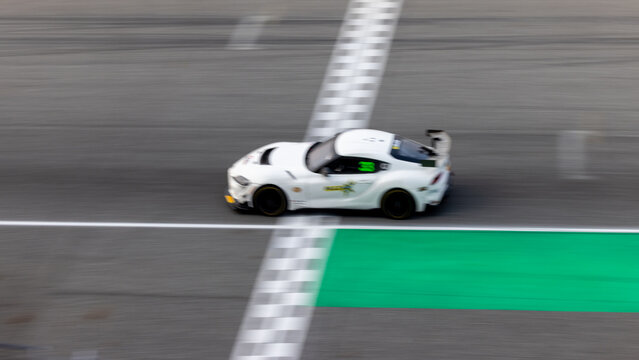 Motion blur, Race car racing on speed track, race car on road crossing start and finish line, Target business achieve and victory concept. .