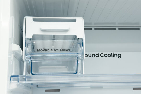 Clean empty movable ice maker inside modern refrigerator