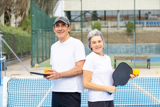 Happy older couple enjoying pickleball sport
