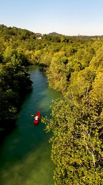 Explore the tranquil waters of Koh Phayam as kayakers glide through stunning mangrove forests. This idyllic holiday destination invites guests to unwind in nature beauty of Thailand