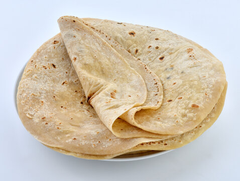 Fresh folded chapatis stacked neatly on a serving plate