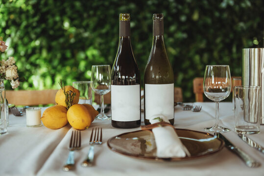 Set table with two bottles of white-labeled wine for a wedding