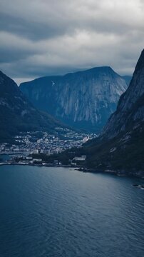 Mountain valley with river under cloudy sky