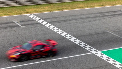 Fotobehang F1 Motion blur, Race car racing on speed track, race car on road crossing start and finish line, Target business achieve and victory concept.  © Kalyakan