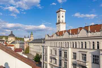 Obraz premium Lviv City Hall tower and old town skyline under blue sky