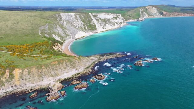 Tracking aerial shot of Mupe Bay and Jurassic coastline looking East in Dorset