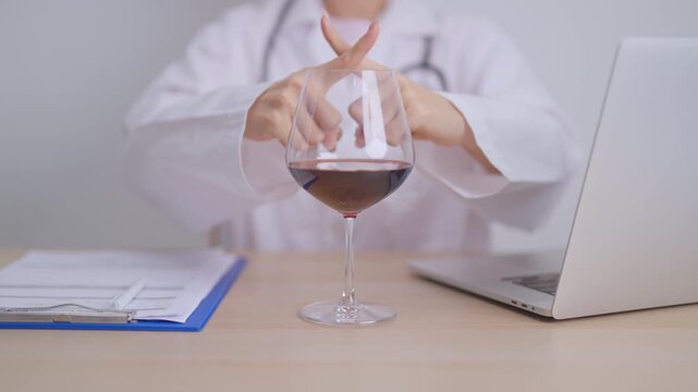 Doctor hand stop to refuse Wine, quitting drink for healthy liver, prevent Alcoholic cirrhosis and cancer, World No Alcohol Day, medical advice for sobriety and Alcoholism and addiction concept