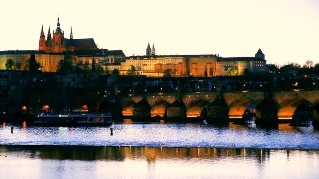 Witness the stunning silhouette of Pragues landmarks as the sun sets. Enjoy the tranquil waters of the Vltava River and the lights shimmering on the historic bridges as night falls.