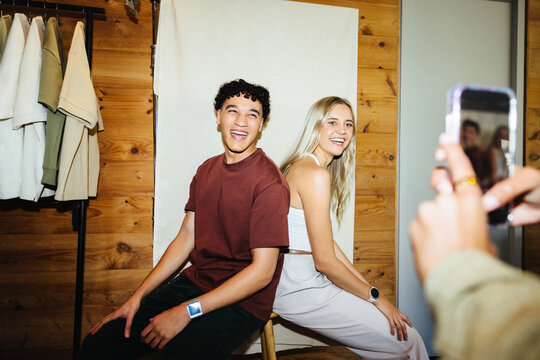 Friends laughing together during a recording session for social media content