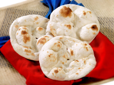 Naan, a traditional Pakistani / Indian flatbread, served on a plate