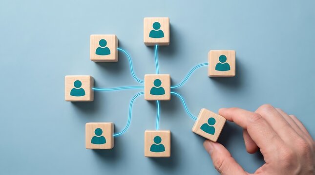 Hand adds person icon block to centralized network structure with connection communication organization business structure