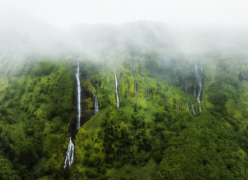 Azores - Drone view of Waterfalls with lake Poco Ribeira do Ferreiro in green landscape, Poco da Alagoinha, Fajazinha, Flores Island, Portugal, Europe
