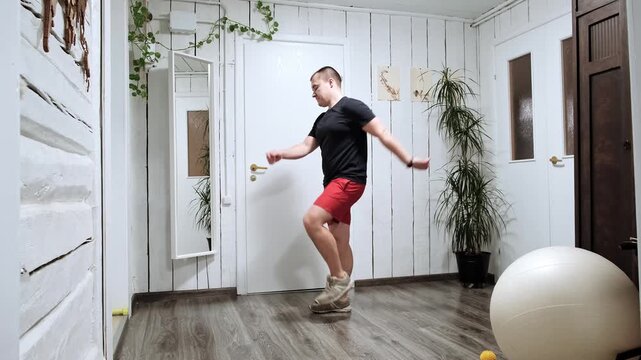 Caucasian man walking on the spot. Person doing an exercise stepping in place at home. Quick lazy workout. Strengthening the legs muscles. Body movement. Healthy lifestyle. High quality 4k footage.