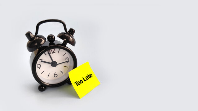 Alarm clock with sticky note &ldquo;Too Late&rdquo; symbolizing missed deadlines, regret, and poor time management.