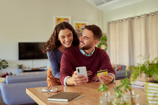 Couple doing online shopping with phone and credit card