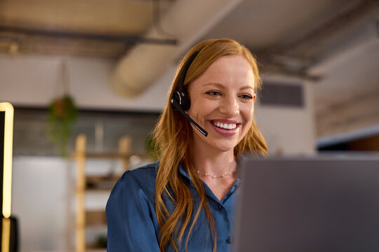 Customer care redhead woman working in a casual call center