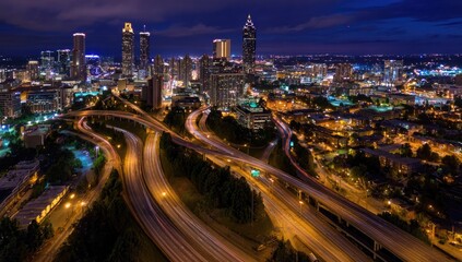Fototapeta premium A stunning aerial view captures the illuminated cityscape of Atlanta at night, showcasing its intricate highway system.