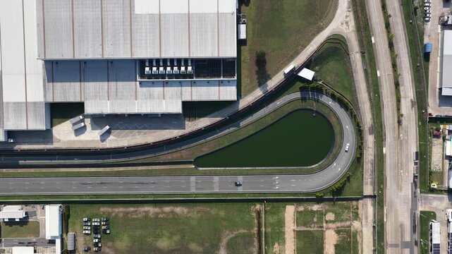 Aerial top down view of cars driving on a test track