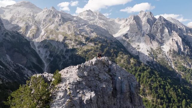 Aerial view of the rugged mountains, with rocky peaks contrasting against the deep green forests in a scenic landscape, Teth, Shkoder County, Albania.