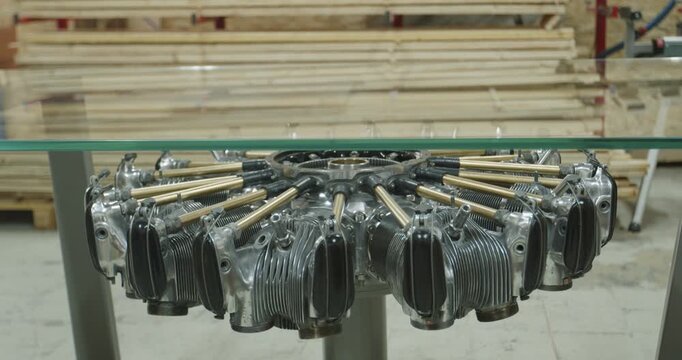 Radial aircraft engine repurposed as a base for a glass top coffee table in a workshop