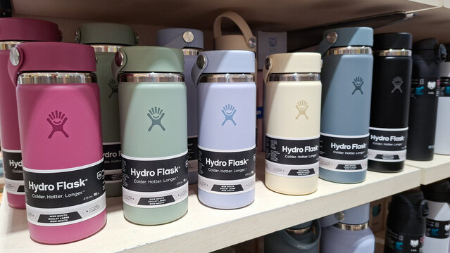 Collection of colorful Hydro Flask reusable insulated stainless steel water bottles displayed on a retail shelf in a department store on April 16, 2026 in Bangkok, Thailand.