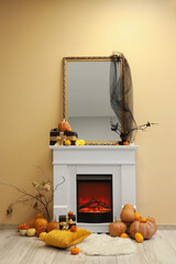 Obraz premium White fireplace with pumpkins, Halloween decor and mirror near yellow wall