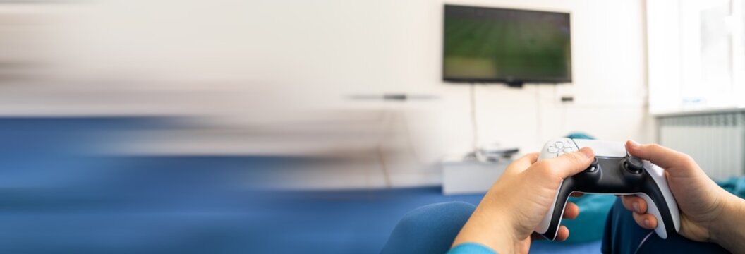 Young man intensely focused on gambling game with money and cards on table, symbolizing addiction, financial risk, emotional stress, and problematic betting behavior.