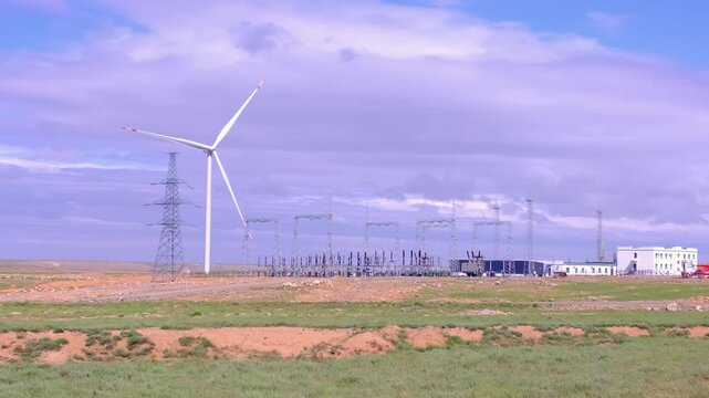 Fleet of power generators in motion. The blades of the wind farm rotate against the sky. The concept of extracting electricity from renewable sources. Wind turbine to generate electricity.