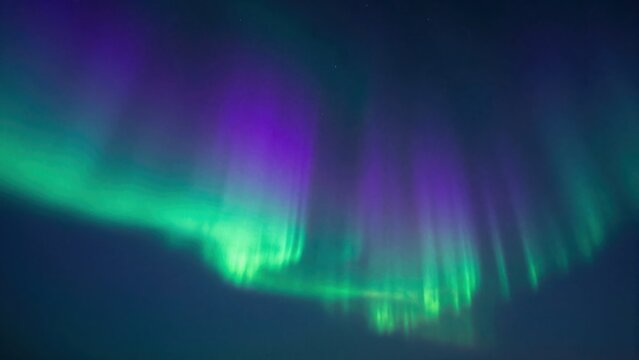 Mesmerizing Display of Aurora Borealis in Vibrant Greens and Purples Lighting up the Night Sky