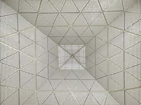 Modern architectural ceiling with geometric pattern and symmetry design inside building interior