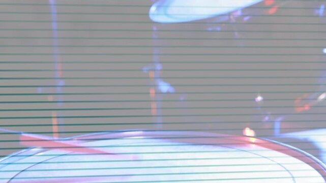 Drum head holding while cymbal swinging in, scanlines overlaying red or blue lights for music shot
